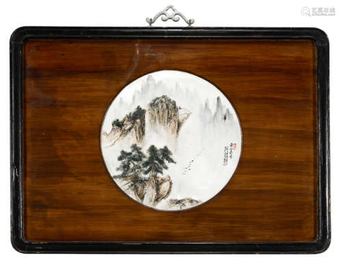 A PAINTED LANDSCAPE PORCELAIN PANEL MOUNTED IN A WOODEN FRAME