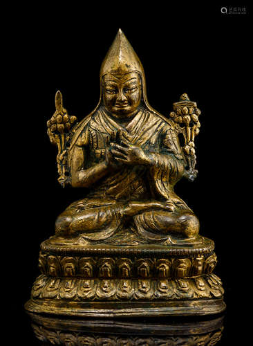 A BRONZE FIGURE OF A LAMA