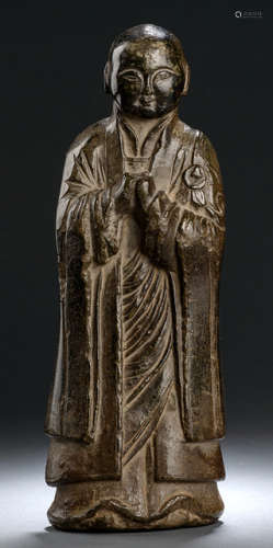 A LIME STONE FIGURE OF A BUDDHIST DISCIPLE