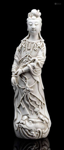 A DEHUA MODEL OF STANDING GUANYIN ON A DRAGON HEAD