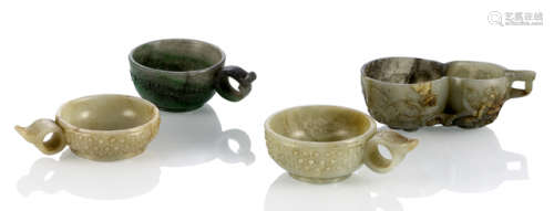A GROUP OF FOUR CARVED JADE CUPS WITH HANDLES