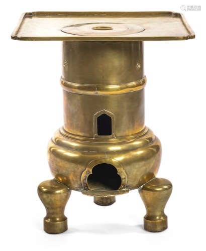 A LARGE BRASS STOVE