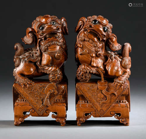A FINELY CARVED PAIR OF BOXWOOD BUDDHIST LIONS