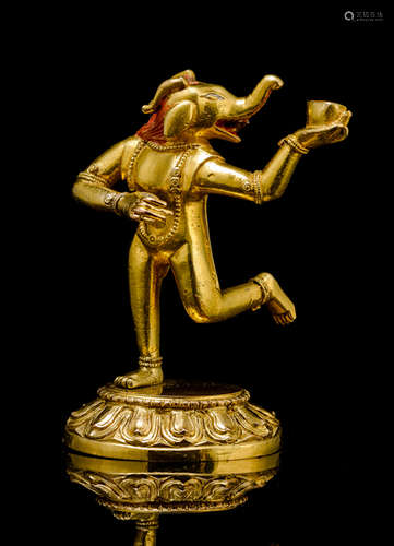 A GILT-BRONZE FIGURE OF AN MAKARAVAKTRA