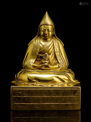 A GILT-BRONZE FIGURE OF A LAMA