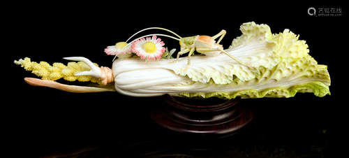 A PAINTED IVORY CARVING OF A CRICKET ON A CABBAGE