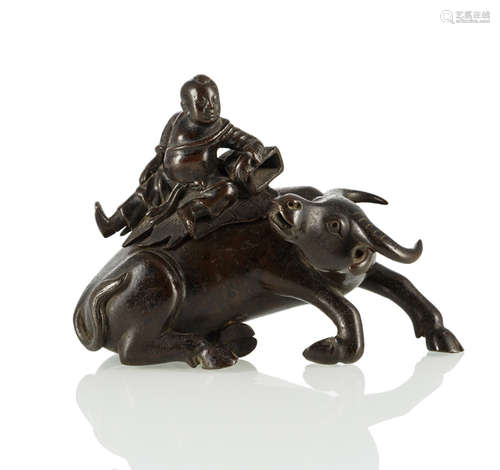 A BRONZE CENSER IN THE SHAPE OF A WATER BUFFALO WITH A BOY