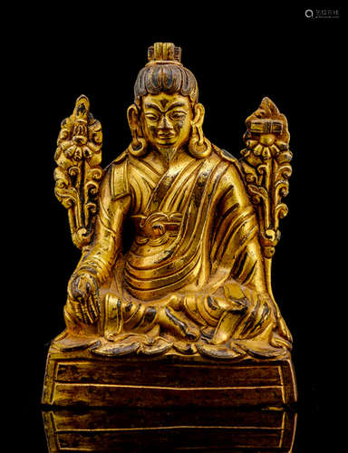 A GILT-BRONZE FIGURE OF A TEACHER