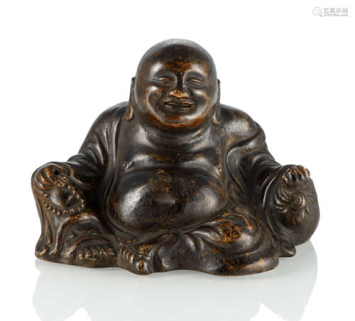 A BROWN-GLAZED BISQUIT PORCELAIN MODEL OF SEATED BUDAI