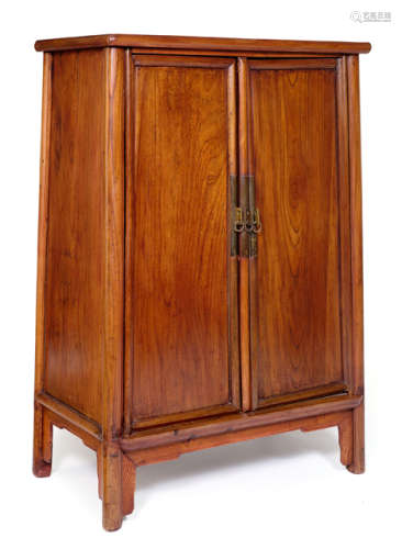 A SMALL HARDWOOD CABINET WITH ROUND CORNERS