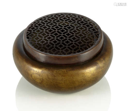 A BRONZE HAND WARMER WITH OPENWORK COVER