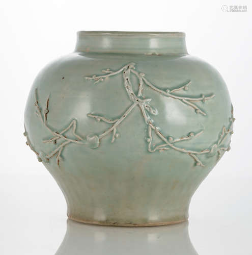 A CELADON-GLAZED JAR WITH PRUNUS TWIGS IN RELIEF