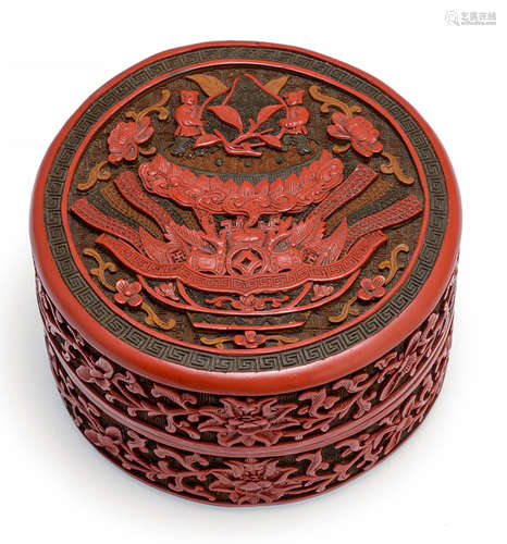 A FINELY CARVED THREE-COLORED CINNABAR LACQUER BOX AND COVER WITH EMBLEM