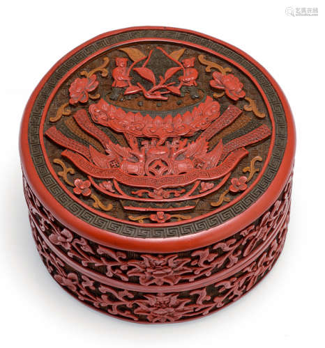 A FINELY CARVED THREE-COLORED CINNABAR LACQUER BOX AND COVER WITH EMBLEM