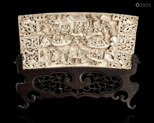 AN IVORY RELIEF CARVING DEPICTING A BUSTLING VILLAGE SCENE