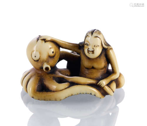 A CARVED IVORY NETSUKE OF A FEMALE DIVER WITH OCTOPUS