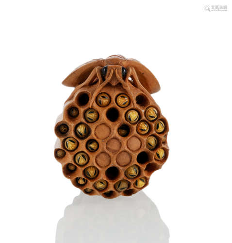 A FINE CARVED BOXWWOD WASP NEST WITH SOME MOVABLE HORN LARVES