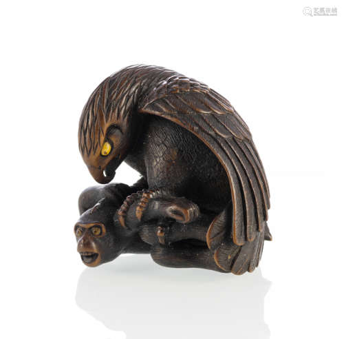 A FINE CARVED WOOD NETSUKE OF AN EAGLE ATTACKING A MONKEY