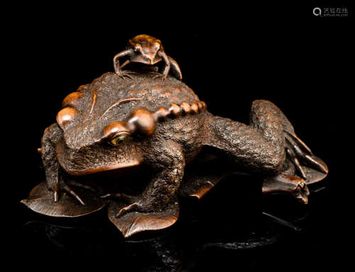 A FINE CARVED BOXWOOD OKIMONO OF A TOAD AND YOUTH ON A MULBERRY LEAF