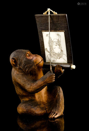 A CARVED WOOD AND IVORY OKIMONO OF A SEATED MONKEY VIEWING A HANGING SCROLL DEPICTING HOTEI