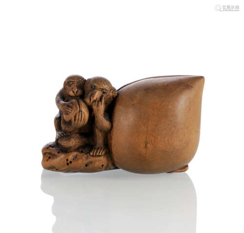 A CARVED BOXWOOD GROUP WITH LARGE PEACH AND MONKEYS