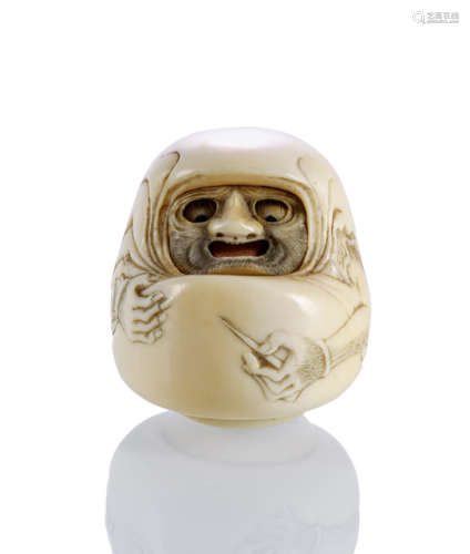 A WELL CARVED IVORY NETSUKE OF A DARUMA PUPPET WITH MOVABLE EYES AND TONGUE