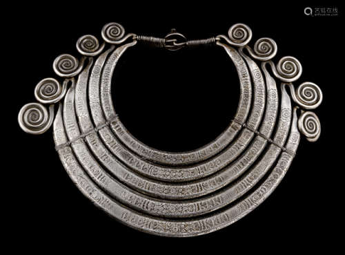 A SILVER TORQUE WITH INCISED FLORAL AND ANIMAL PATTERN