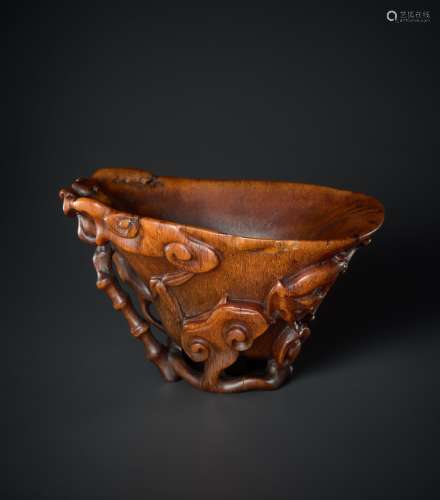 A 'LINGZHI AND CHILONG' CARVED RHINOCEROS HORN LIBATION CUP, MING DYNASTY, 16TH - 17TH CENTURY