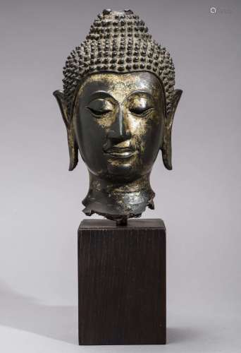 A 15TH CENTURY AYUTTHAYA PERIOD GILT BRONZE HEAD OF BUDDHA