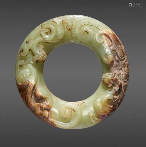 A STUNNING CELADON GREEN DISC EXQUISITELY CARVED WITH TWO CHI DRAGONS IN RELIEF ON TOP AND JOINED CURLS ON THE UNDERSIDE