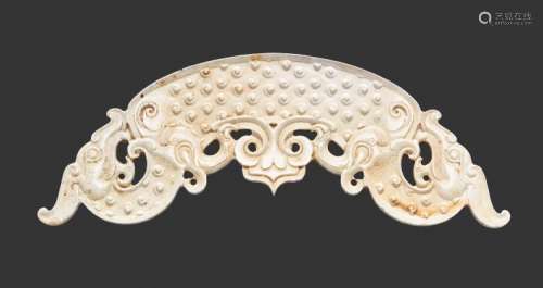 A REMARKABLE HUANG WITH FINELY DETAILED SINUOUS DRAGONS IN IVORY-LIKE JADE