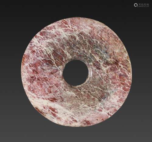 AN AMAZING NEOLITHIC BI DISC IN REDDISH JADE WITH INTRICATE NATURAL VEINING