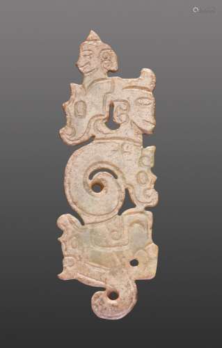 A THIN, FLAT ORNAMENT WITH A COMPOSITE PATTERN OF HUMAN HEADS AND DRAGONS