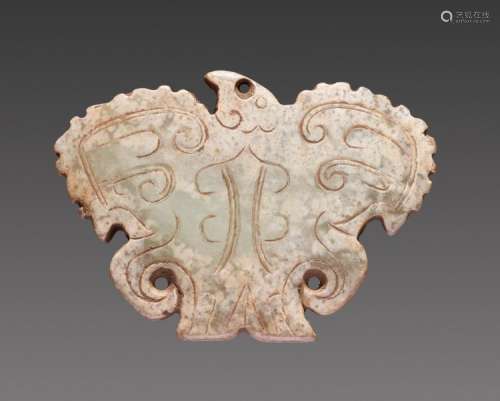 A POWERFUL CARVING OF A HAWK WITH OUTSTRETCHED SCALLOPED WINGS DECORATED WITH INCISED CURLS