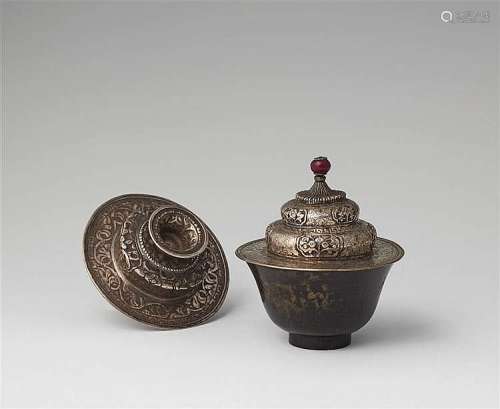A Tibetan black-spotted jade tea cup with silver lid