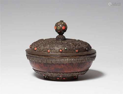 A Tibetan circular burl wood box with a metal lid