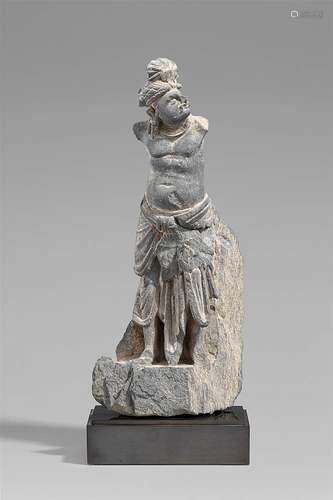 A Gandhara grey schist fragment of a standing man. Pakistan. 2nd/3rd century