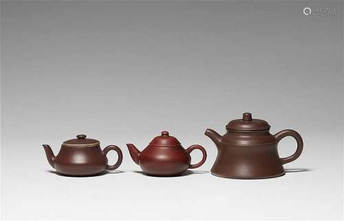 A group of three Yixing teapots and covers. Qing dynasty (1644-1911) and later