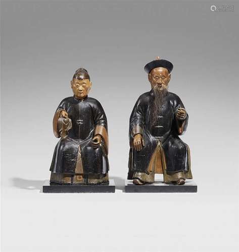 A pair of lacquered and polychromed wood ancestor figures of an old couple. 19th century