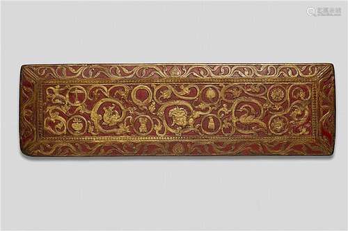 A Tibetan carved, painted and gilt wood manuscript cover. Possibly 14th/15th century