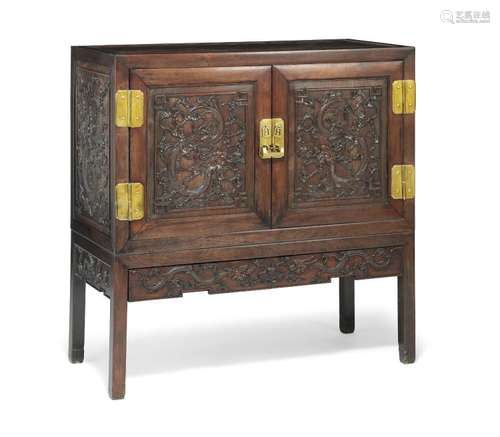 A Chinese richly carved hardwood cupboard. Qing, c. 1900. H. 123 cm. W. 123 cm. D. 56 cm.