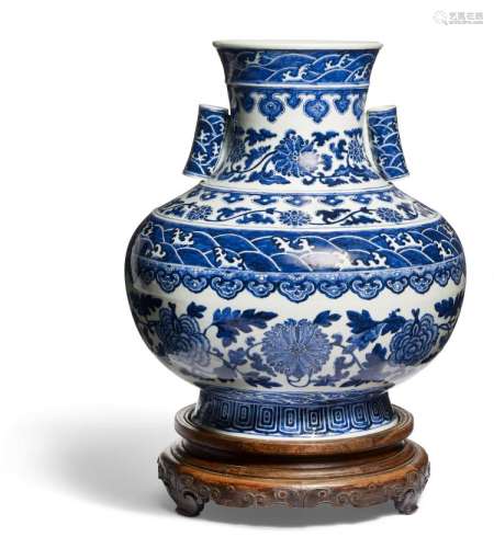 A large Chinese blue and white globular vase with tubular handles. Qianlong mark, c. 1900. H. 43 cm. Fitted wooden stand.