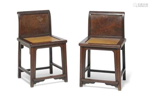 A pair of Chinese hardwood chairs, each with root wood back panels. Qing, late 19th century. (2)