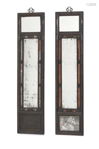 A pair of narrow Chinese mirrors in hardwood frames. 19th/ early 20th century. H. 161 cm. W. 37 cm. (2)