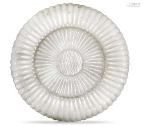 A Chinese pale jade plate carved in the shape of a full-blown chrysanthemum. Marked Qianlong Weight 138 gr. Diam. 16.5 cm.