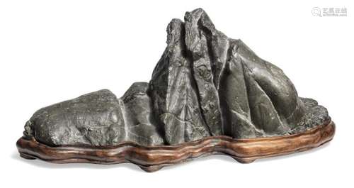 A lingbi scholar's rock. 20th century.H 9 cm incl base. L. 22 cm incl wooden base