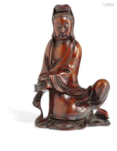 A Chinese Huang Yang Mu, boxwood, figure of a seated Guanyin. Kangxi 1662-1722. H. 20 cm.