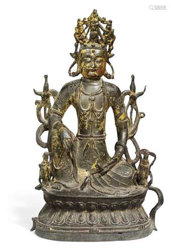 A Chinese patinated bronze figure of Watermoon Guanyin with remains of gilding. Ming 1368-1644. Weight 2630 gr. H. 33 cm.