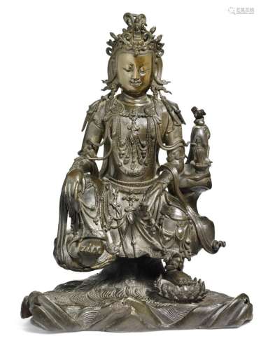 A Chinese patinated bronze figure of Watermoon Guanyin. Ming 1368-1644. Weight 5020 gr. H. 32.5 cm.