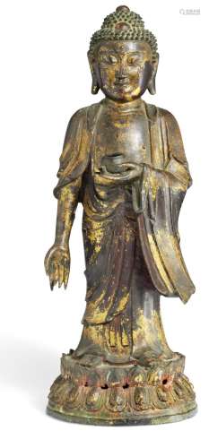 A Chinese patinated bronze Buddha standing in ruched robe left hand holding a bowl, on double lotus. Ming 1368-1644. H. 52 cm.